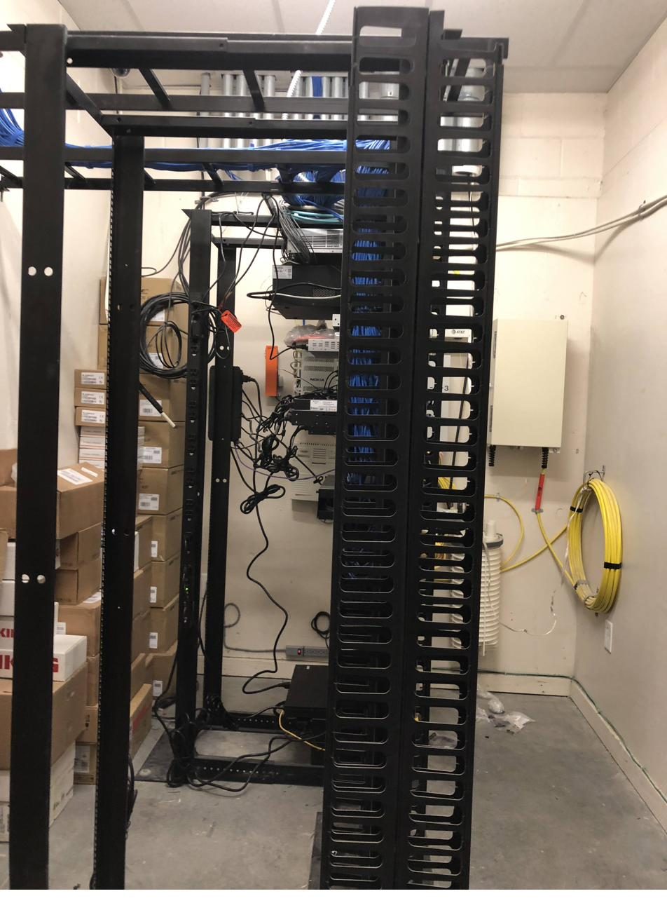Server rack with neatly organized Cat6 cabling and vertical cable management ladder