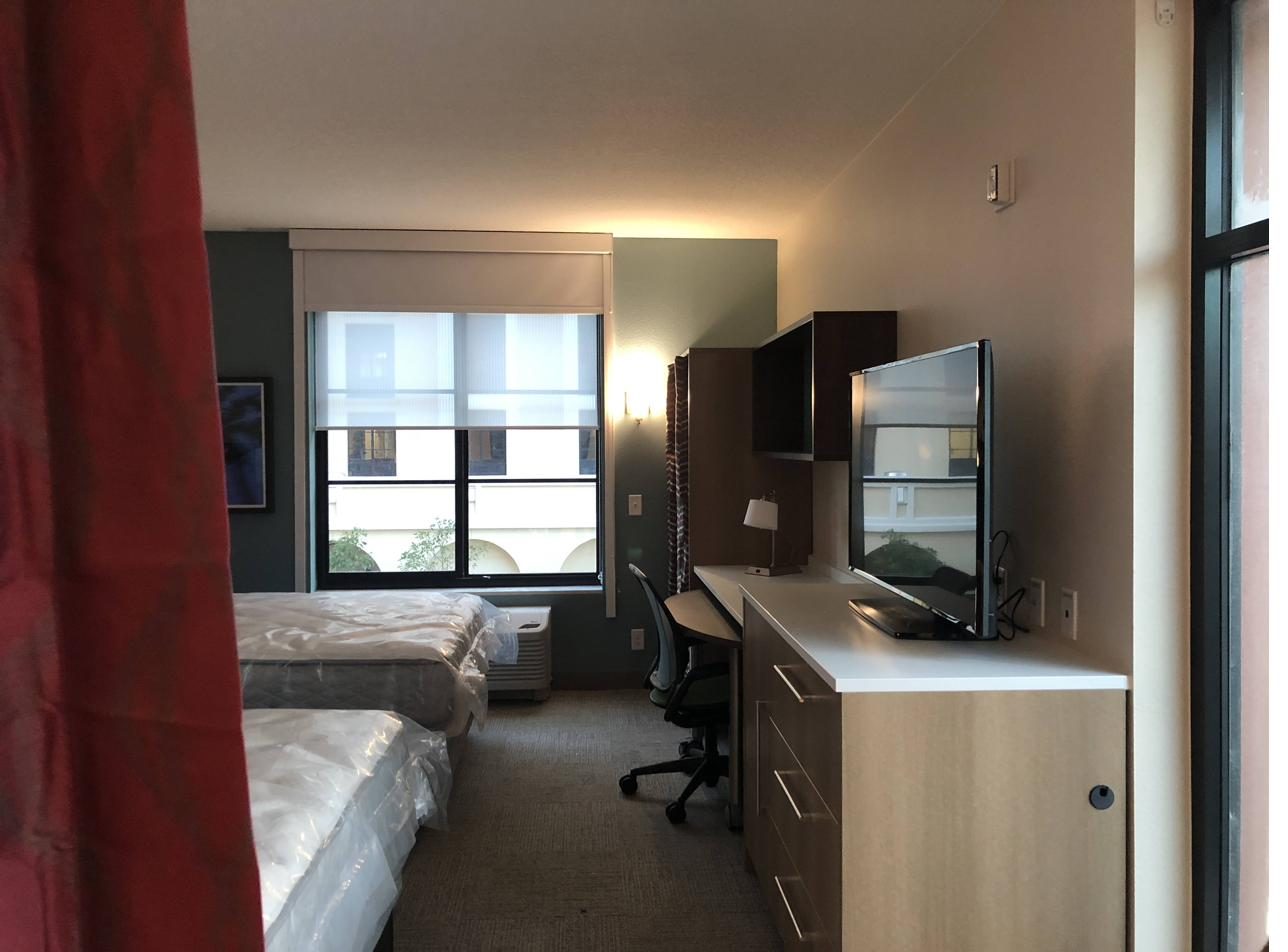 Guest room with case goods — dresser, desk, nightstand and built-in cabinetry